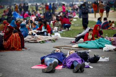 CORRECTS THE DAY TO SUNDAY - In this photo provided by China's Xinhua News Agency, tourists sleep at an open space after an earthquake in Kathmandu, Nepal, Sunday, April 26, 2015. Planeloads of aid material, doctors and relief workers from neighboring countries began arriving Sunday in Nepal, a poor Himalayan nation reeling from a powerful earthquake that destroyed infrastructure, homes and historical buildings.  (Pratap Thapa/Xinhua via AP)